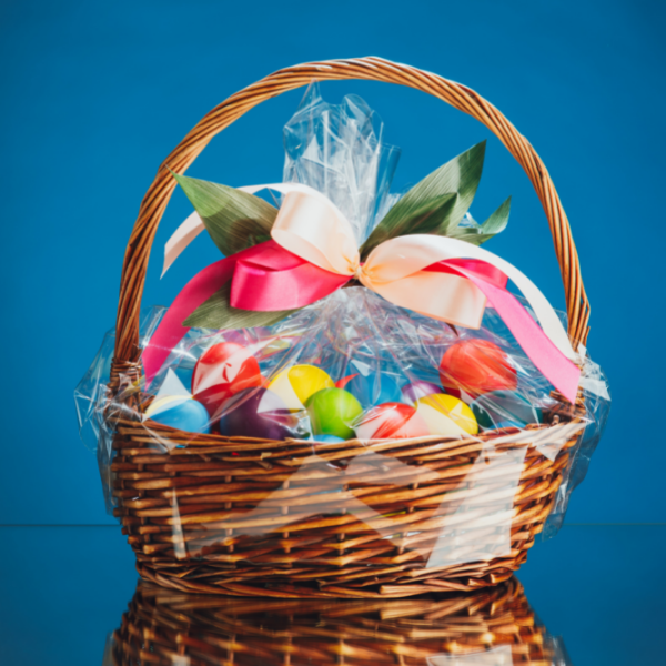Colorful easter eggs in wood basket and wrapped in cello.